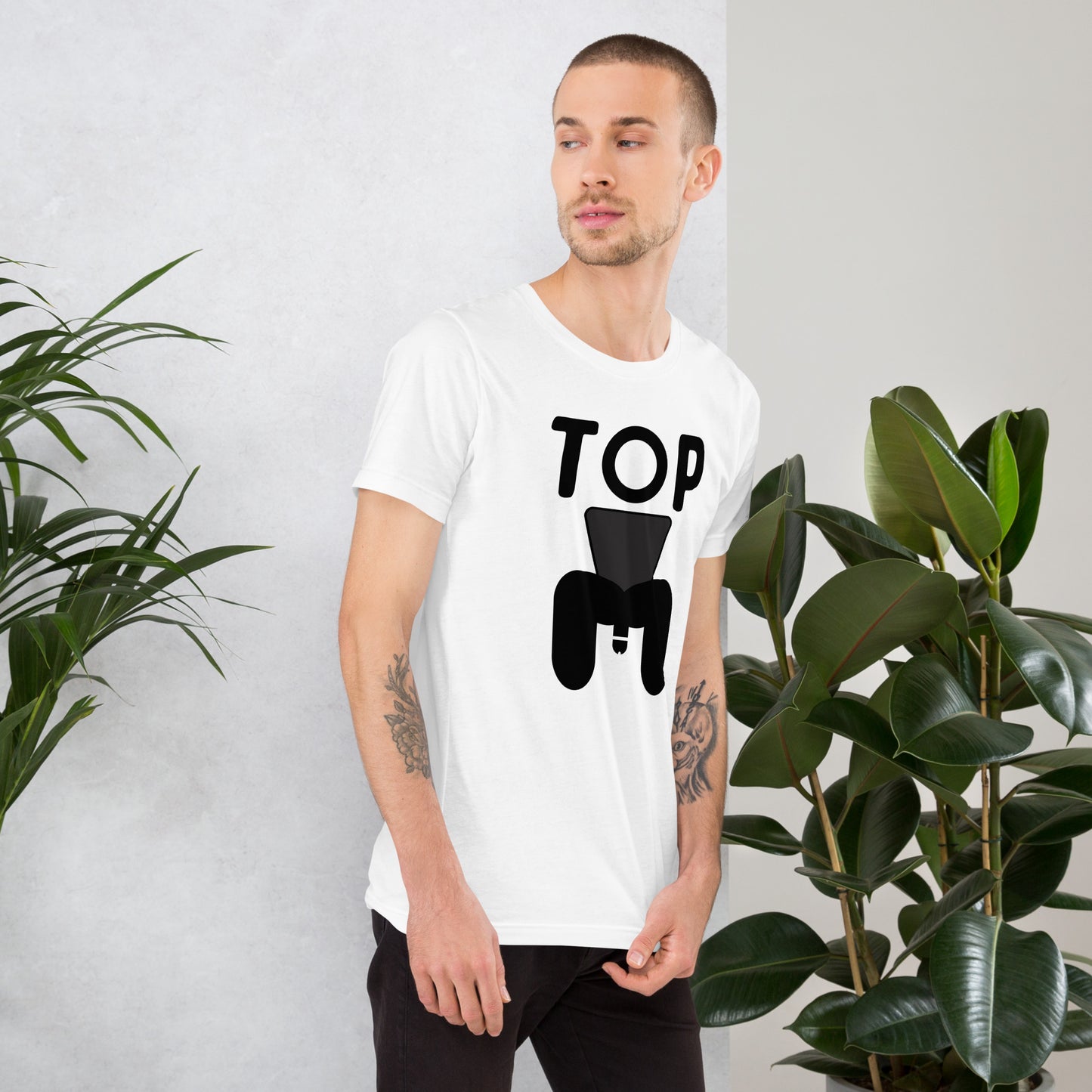 Man wearing a white t-shirt with a black graphic stating "TOP"