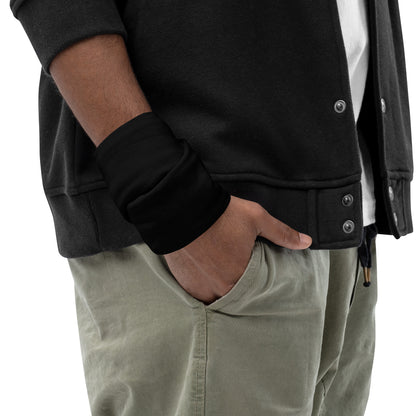 Black Face Cover from the Cuckolding Collection discreetly placed on a wrist before the Fetish Party