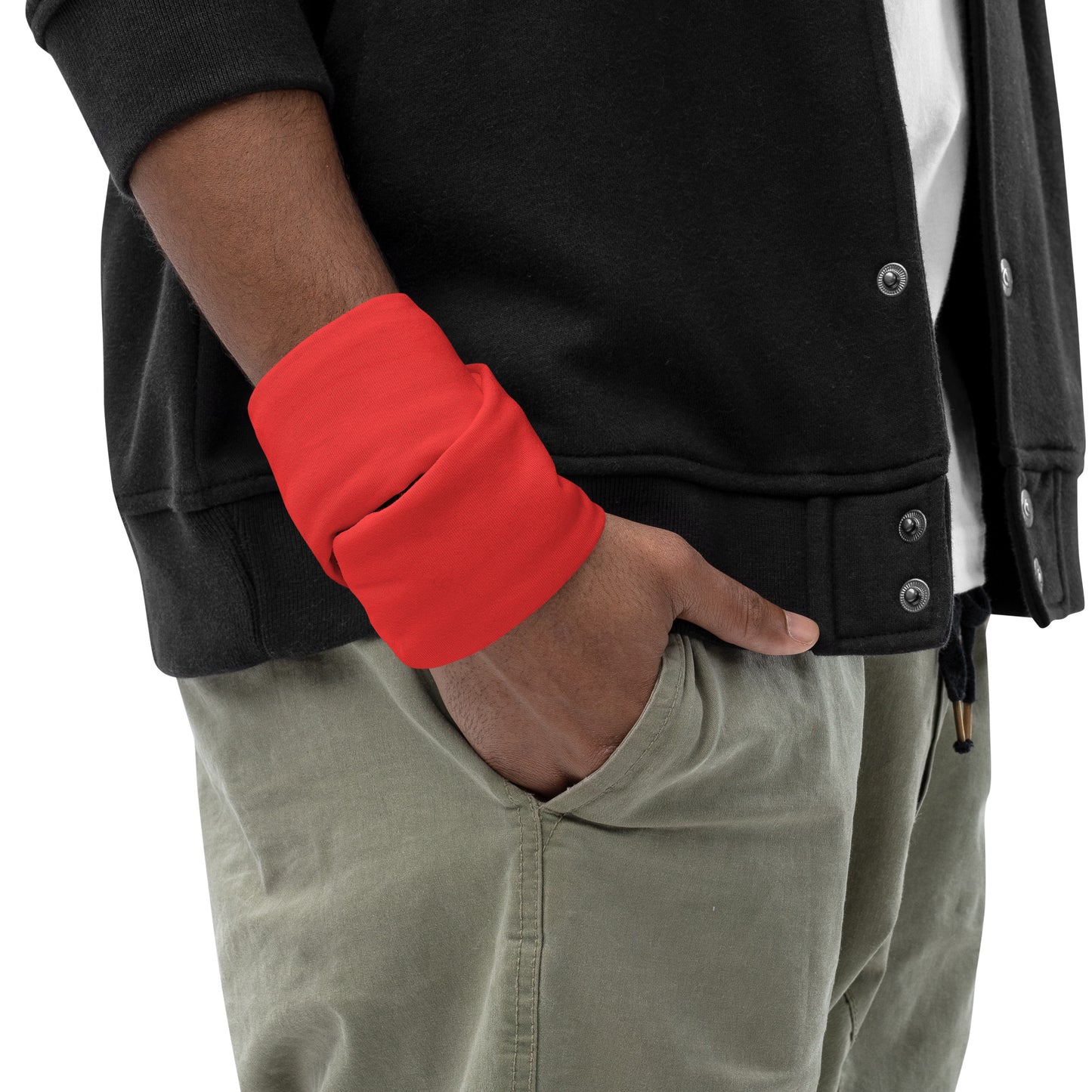 Person wearing a black jacket with red sleeve and beige pants on a white background