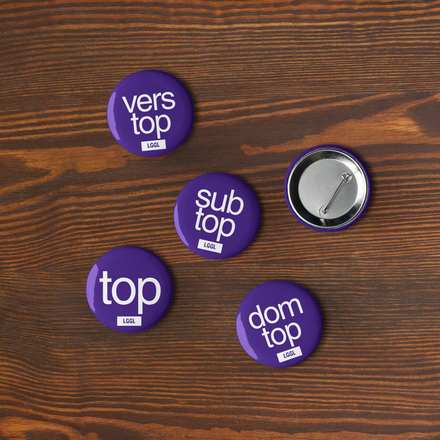Close-up of a blue 56mm gay kink pinback button - Top role fetish badge by LetGoGetLaid