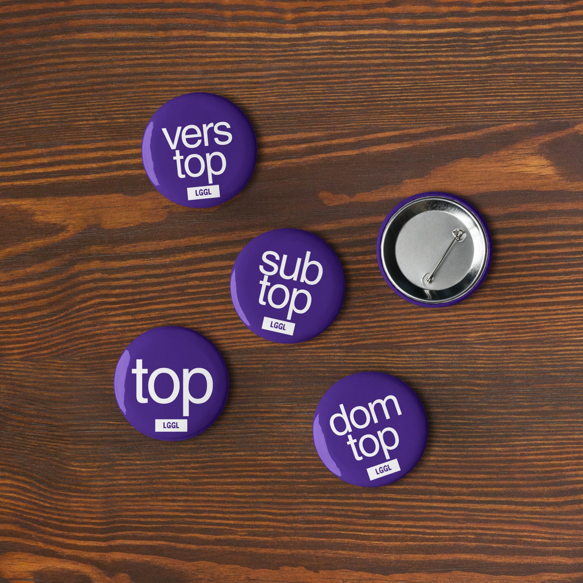 Close-up of a blue 56mm gay kink pinback button - Top role fetish badge by LetGoGetLaid