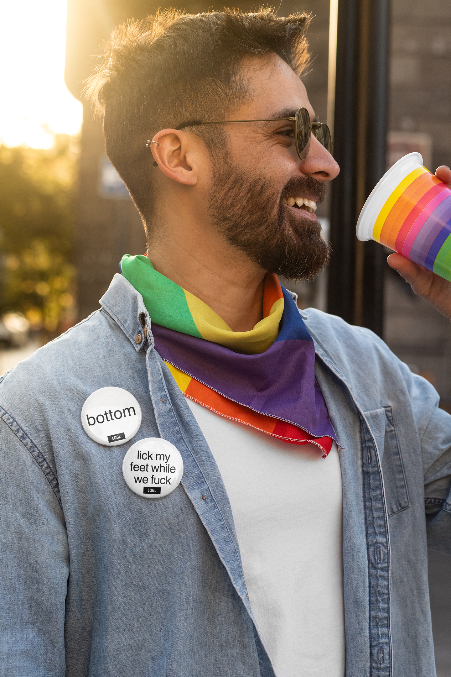 A gay man celebrating a gay feet fetish party wearing LGGL pin buttons
