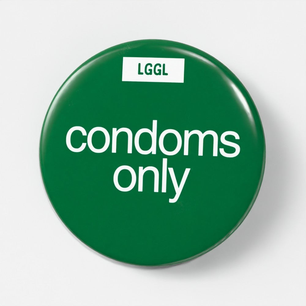 56mm gay fetish pin badge printed with "Condoms Only" - safe kink role badge