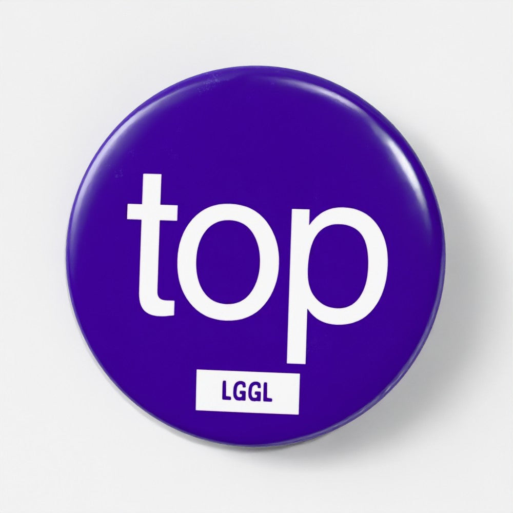 Round blue pin badge featuring "top" text