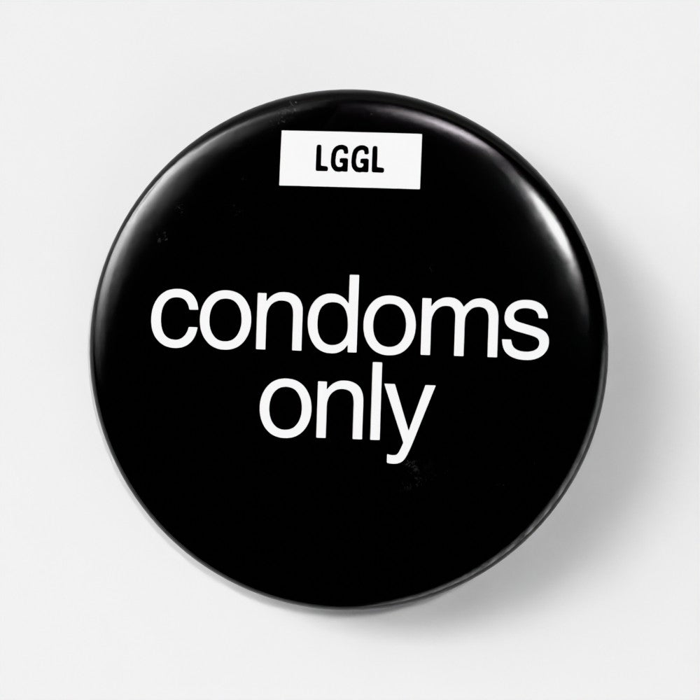 Let Go Get Laid black pin badge with statement "condoms only"