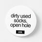 A pin badge featuring a statement about used dirty socks