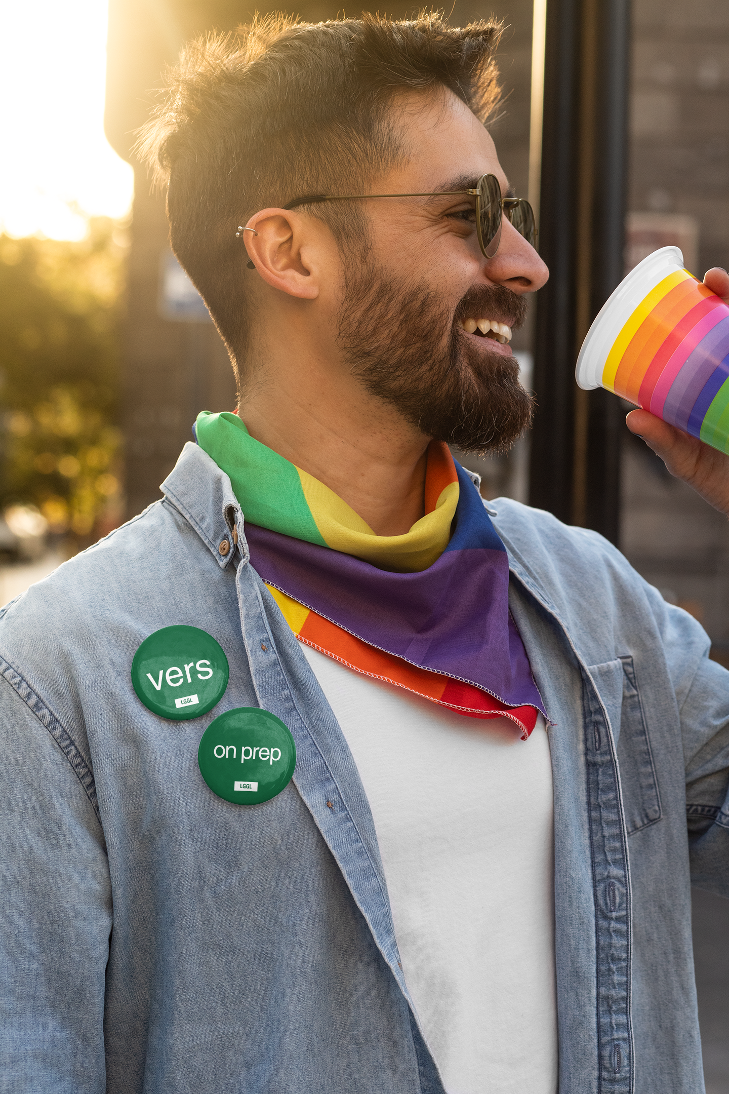 Happy man celebrating LGBT pride wearing badges