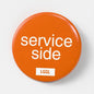 LetGoGetLaid 56mm pin badge featuring "Service Side" - gay oral and side play kink accessory