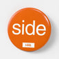 Orange 56mm pin badge printed with "Side" - gay side role kink badge by LetGoGetLaid