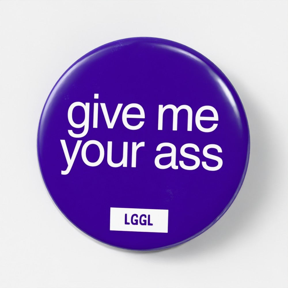 Blue 56mm gay fetish pin badge printed with "Give Me Your Ass" - explicit top kink badge