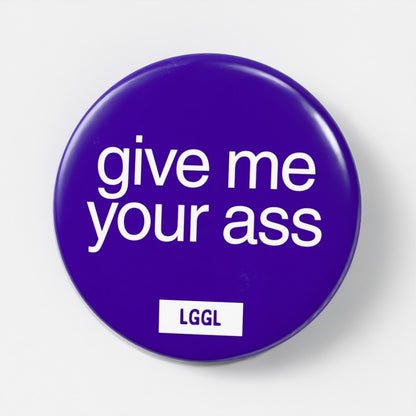 Blue 56mm gay fetish pin badge printed with "Give Me Your Ass" - explicit top kink badge