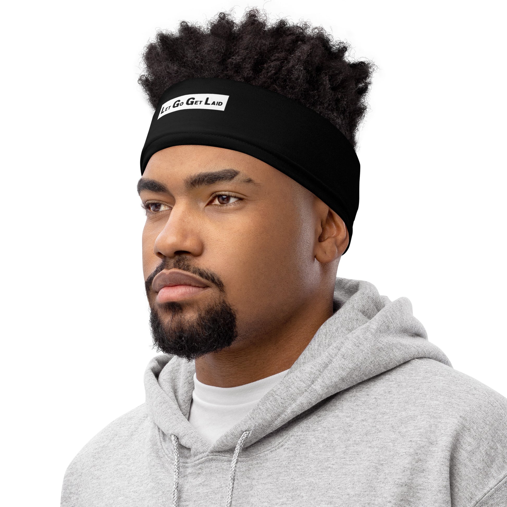 Man wearing a black "Let Go Get Laid" headband on a white background